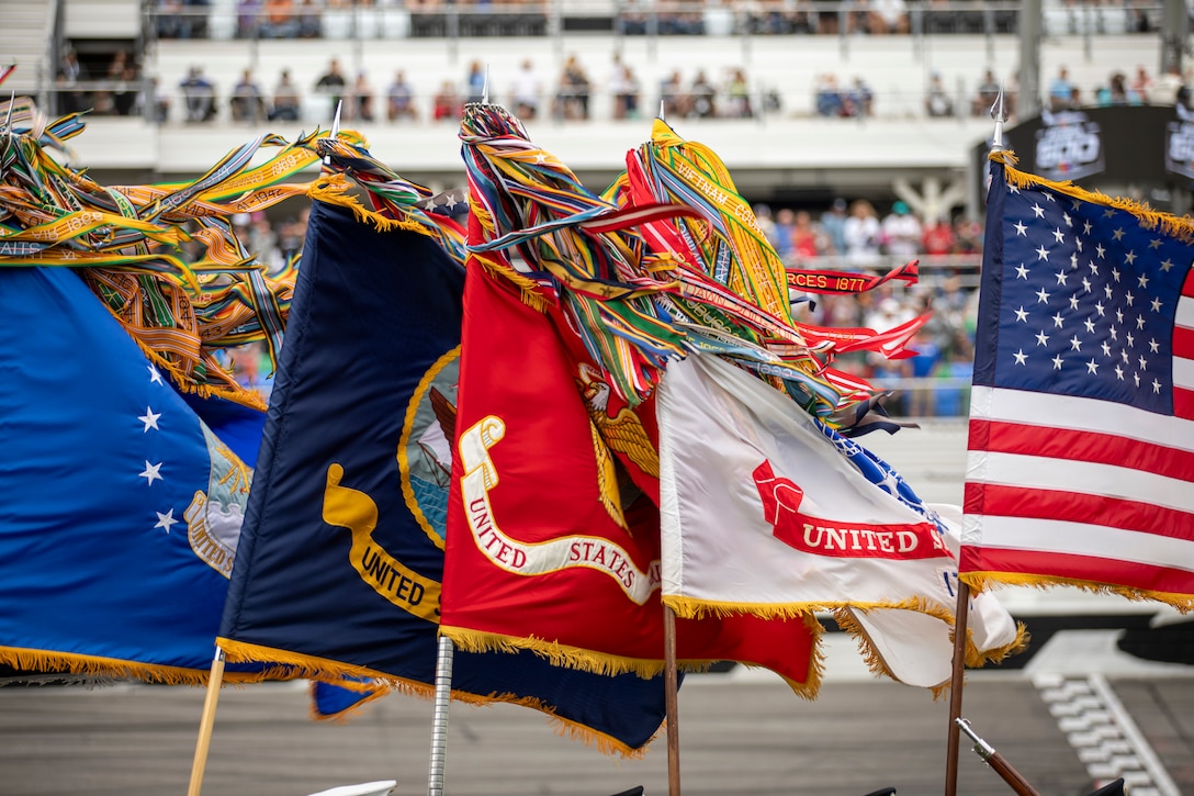 Wind blows the flags of a Military District of Washington Joint Armed Forces Color Guard