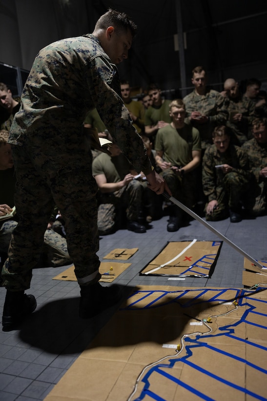 U.S. Marine Corps 2nd Lt Jacob Lerch, a platoon commander with 4th Law Enforcement Battalion, Force Headquarters Group, briefs a terrain model to Marines in Elvegardsmoen, Norway, March 2, 2026. The brief helped familiarize the Marines with the Norwegian terrain during Cold Responses 26. A key component of NATO's enhanced vigilance activity Arctic Sentry, exercise Cold Response 26 is a Norwegian-led winter military exercise designed to enhance collective defense capabilities and ensure U.S. readiness to rapidly deploy and seamlessly operate alongside NATO Allies in challenging arctic conditions. Lerch is a native of Washington. (U.S. Marine Corps photo by Sgt. Emily De La Torre)