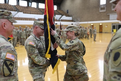 Col. Elizabeth Roxworthy receives the Brigade’s flag from Command Sgt. Maj. Joseph Cistaro during a change of command ceremony