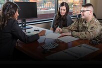 Soldier and spouse speak with a personal financial counselor
