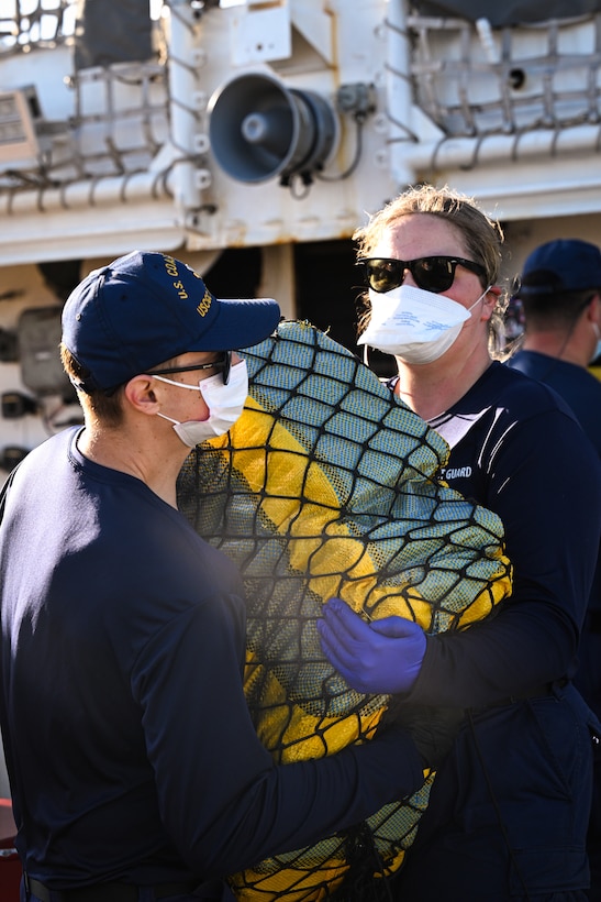 Crewmembers from Coast Guard Cutter Forward (WMEC-911) offload illicit narcotics in Port Everglades, Florida, March 19, 2026. The offload contained an estimated $49.3 million in cocaine the Coast Guard and its partners intercepted in the international waters of the Eastern Pacific Ocean. (U.S. Coast Guard photo by Seaman Christopher Moret)