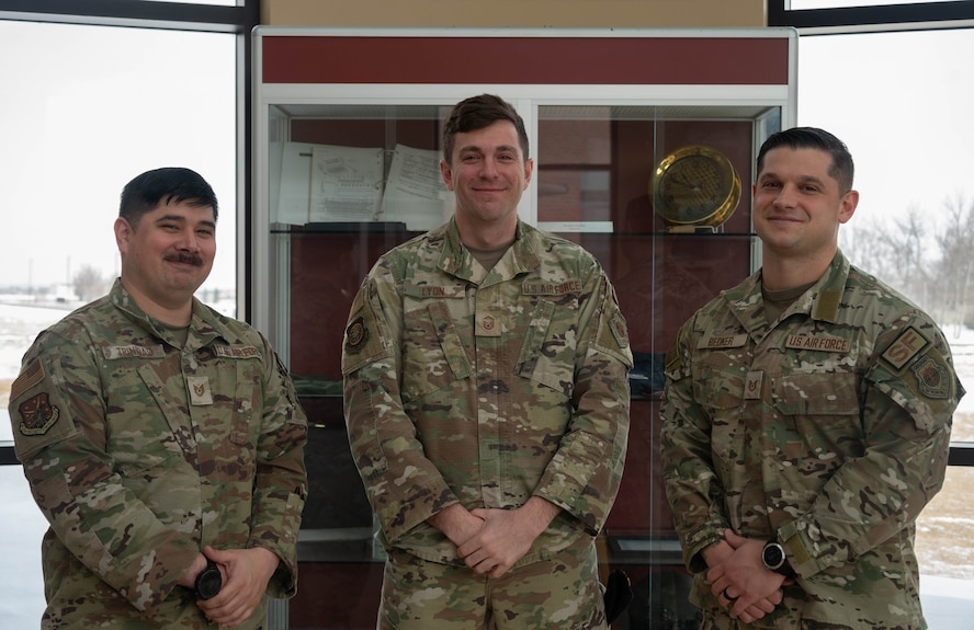 U.S. Air Force Tech. Sgt. Brandon Trinidad, 91st Security Forces Group chief of weapons and tactics (left), U.S. Air Force Master Sgt. Chad, 20th Air Force chief of weapons and tactics for ICBM security forces operations (middle) and U.S. Air Force Tech. Sgt. Aaron Bedker, 91st Missile Security Operations Squadron NCOIC weapons and tactics pose for a photo during a Nuclear Security Operations Tactics, Techniques and Procedures rewrite at Minot Air Force Base, North Dakota, Feb. 25, 2026. The rewrite establishes standardized procedures that ensure consistency, interoperability and mission assurance across the enterprise. (U.S. Air Force photo by Airman 1st Class Wesley Davies)