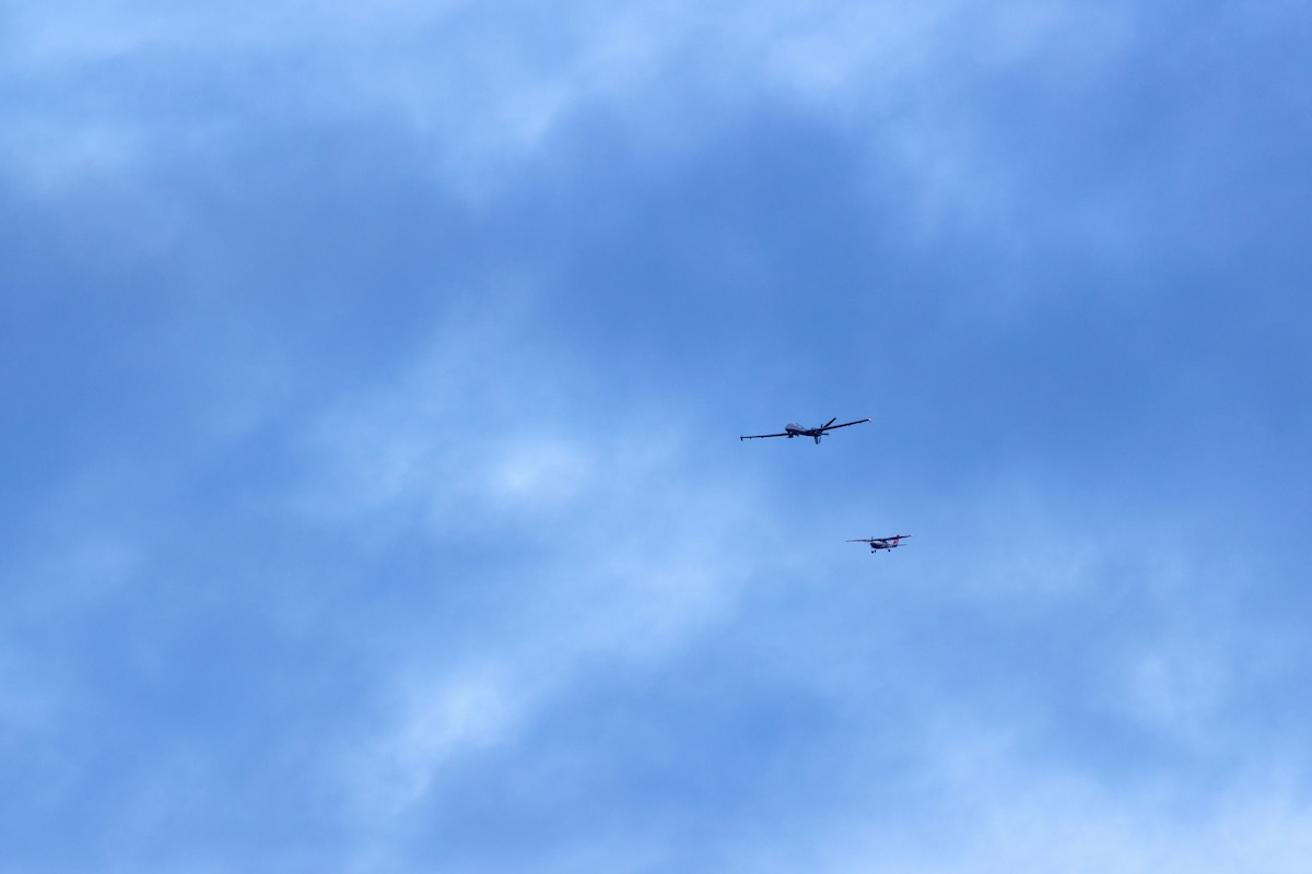 A U.S. Air National Guard MQ-9 Reaper unmanned aircraft system with the 214th Attack Group, intercepts a Civil Air Patrol aircraft during a training flight above Davis-Monthan Air Force Base, Ariz., Mar. 10, 2026. The historic flight from  the aircraft's main operating base at Fort Huachuca, Ariz., served to validate new flight procedures between the two southern Arizona locations, creating the framework for future operations. (U.S. Air National Guard photo by Tech. Sgt. Stephen Luke)