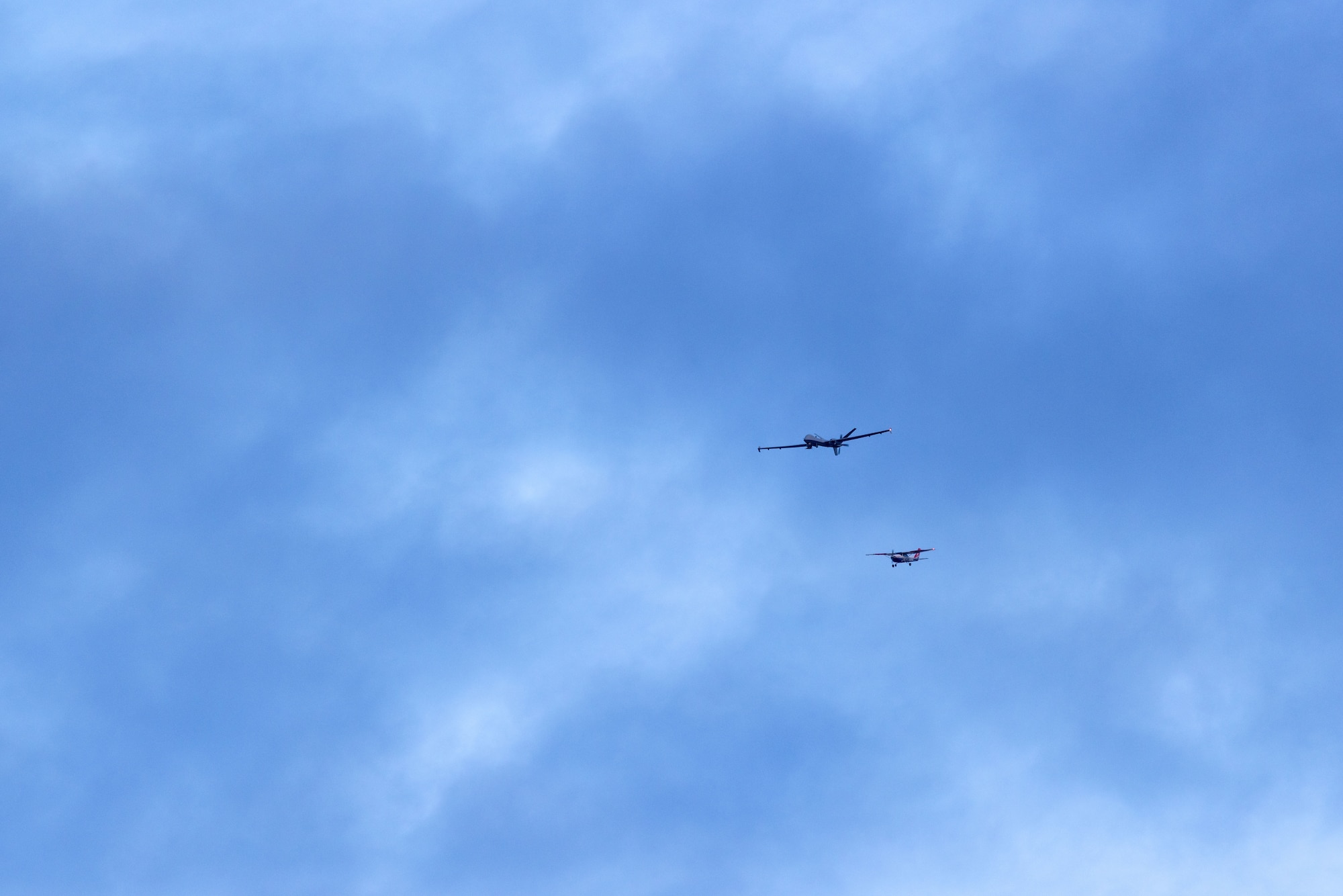 A U.S. Air National Guard MQ-9 Reaper unmanned aircraft system with the 214th Attack Group, intercepts a Civil Air Patrol aircraft during a training flight above Davis-Monthan Air Force Base, Ariz., Mar. 10, 2026. The historic flight from  the aircraft's main operating base at Fort Huachuca, Ariz., served to validate new flight procedures between the two southern Arizona locations, creating the framework for future operations. (U.S. Air National Guard photo by Tech. Sgt. Stephen Luke)