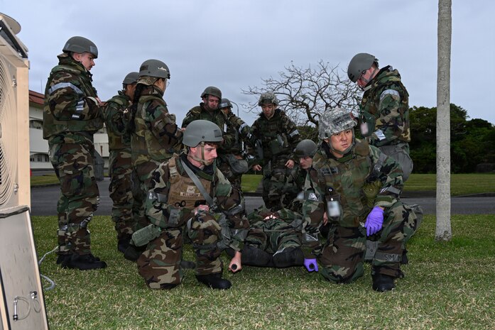 U.S. Sailors with 3rd Medical Battalion, 3rd Marine Logistics Group, and U.S. Air Force Airmen with 18th Medical Group, 18th Wing, treat a simulated patient during Exercise Beverly Midnight 26 at Kadena Air Base, Okinawa, Japan, March 12, 2026. 3rd Medical Battalion provided medical support during BM26, enabling the 18th Wing to test its response capabilities. This integrated effort sharpened the ability of both units to deliver critical care side-by-side, reinforcing a unified medical front ready for any crisis in the Indo-Pacific. (U.S. Marine Corps photo by Lance Cpl. Rachel Mason)
