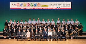 A group of people poses on stage.