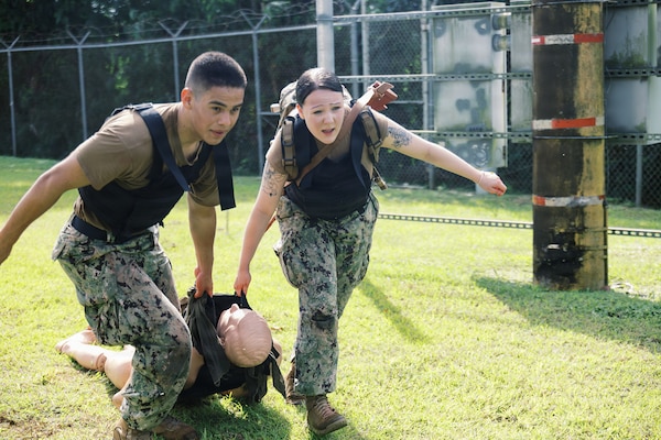 AGANA HEIGHTS (Dec.17, 2025) – Hospitalman Jose Jaramillo and Hospitalman Sarah Garza- Annalla conduct a casualty movement drill during Tactical Combat Casualty Care (TCCC) training at Naval Hospital Guam. The Sailors, who are assigned to U.S. Navy Medicine Readiness and Training COMMAND (NMRTC) Guam, practiced evacuating a simulated casualty while maintaining balance, communication, speed and skills essential for moving wounded personnel to cover and transitioning care during combat-related mass casualty events held at U.S. Naval Hospital Guam. (U.S Navy photo Petty Officer 3rd Class Oluwatomiwo Sogaolu). Photo name: 251217-N- EM93 -2015