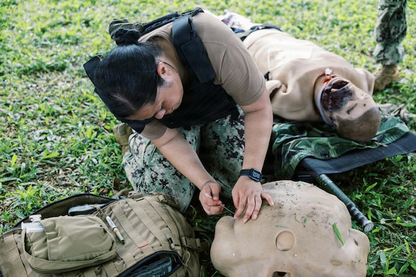 AGANA HEIGHTS (Dec.17, 2025) – Hospital Corpsman 3rd Class Sheralyn Leota, assigned to U.S. Navy Medicine Readiness and Training Command (NMRTC) Guam, performs needle decompression on a training manikin during Tactical Combat Casualty Care (TCCC) training at U.S. Naval Hospital Guam. The scenario focused on relieving pressure in the chest to help the casualty breathe, reinforcing quick decision-making and lifesaving actions needed during combat trauma situations. (U.S Navy photo Petty Officer 3rd Class Oluwatomiwo Sogaolu). Photo name: 251217-N- EM93 -2059