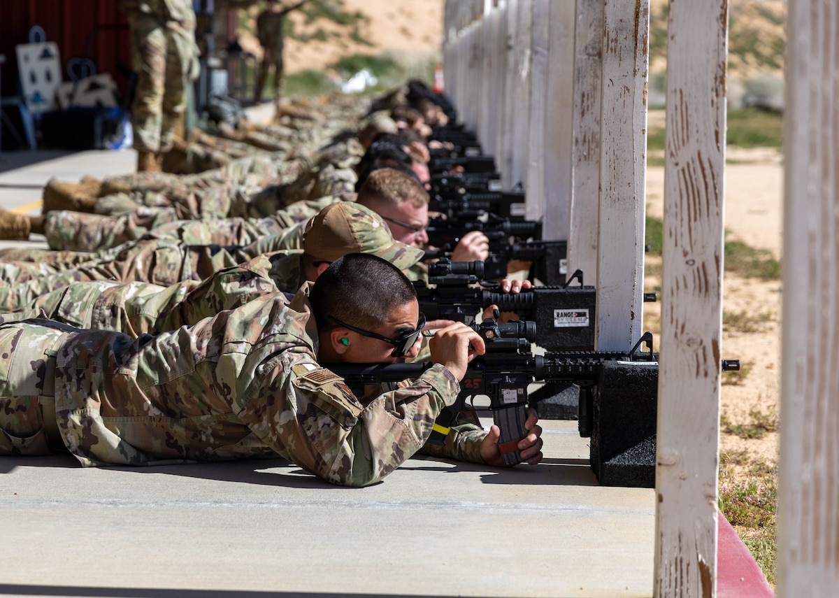 Airmen from the 412th Test Wing shoot at targets with their M-4 rifles during live-fire training at the Combat Arms Training and Maintenance range at Edwards Air Force Base, Calif., Feb. 26, 2026. The training reinforces weapons proficiency, safety procedures and mission readiness for base personnel. (U.S. Air Force photo by Todd Schannuth)