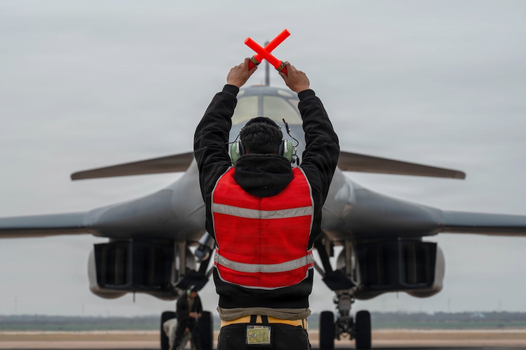 Airman marshaling B-1B
