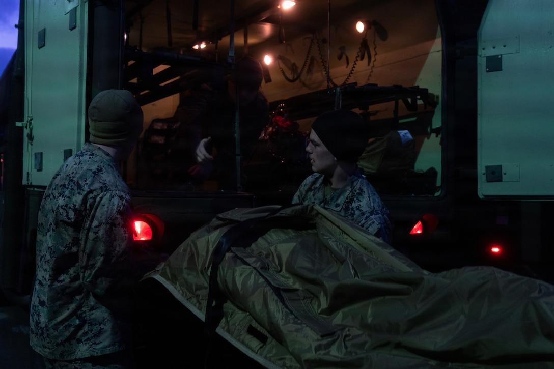 U.S. Navy hospital corpsmen with 2nd Battalion, 6th Marine Regiment, 2nd Marine Division, move simulated casualties in the back of a M997A3 Humvee Ambulance as part of an en route casualty care training scenario training scenario in Setermoen, Norway, March 15, 2026. The simulated mass-casualty and en route care training tested a variety of new technologies during exercise Cold Response 26, such as the Mobile Integrated Remains Collection System, the Mortuary Affairs Reporting and Tracking System, the Operational Medicine Care Delivery Platform, the Battlefield Assisted Trauma Distributed Observation Kit-Joint, and the Expeditionary Medical Refrigeration Unit. A key component of NATO's enhanced vigilance activity Arctic Sentry, exercise Cold Response 26 is a Norwegian-led winter military exercise designed to enhance collective defense capabilities and ensure U.S. readiness to rapidly deploy and seamlessly operate alongside NATO Allies in challenging arctic conditions. (U.S. Marine Corps photo by Lance Cpl. Javier Santillan)