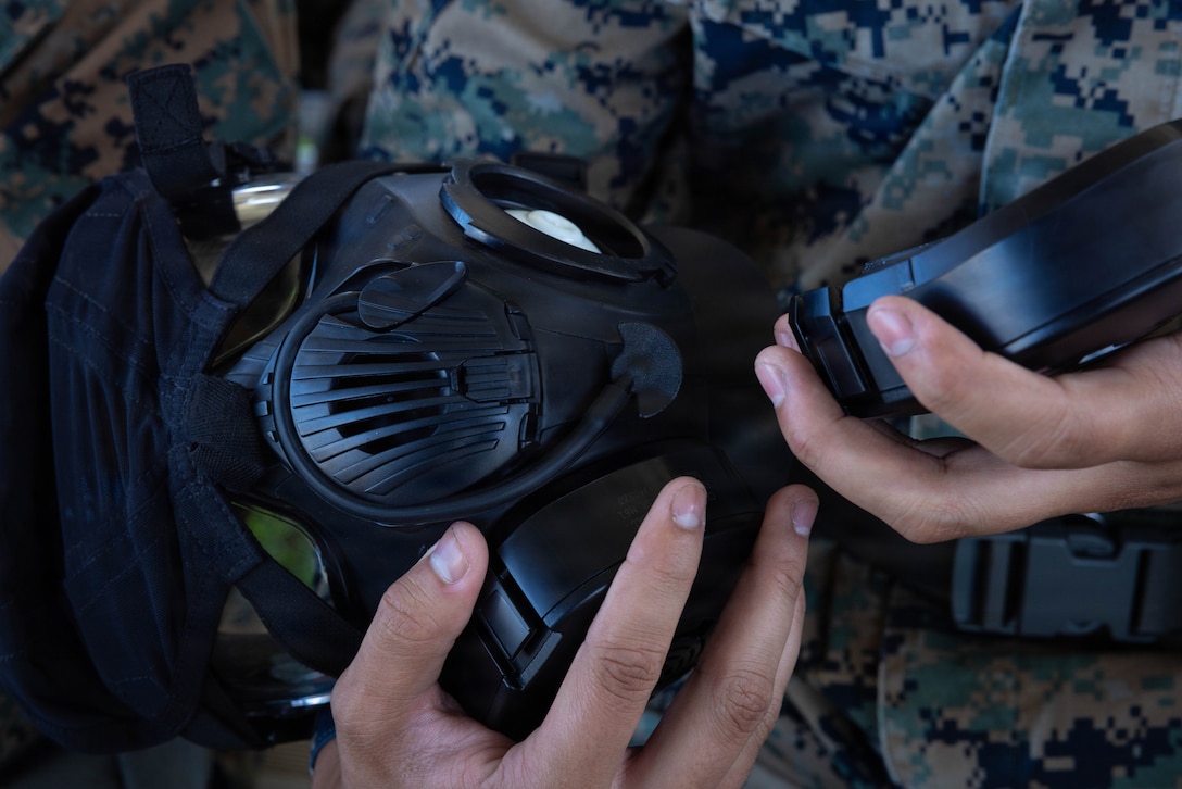 A U.S. Marine with 4th Medical Battalion, 4th Marine Logistics Group, Marine Forces Reserve, practices taking on and off the filter of a gas mask during a Reserve Mobilization Exercise, East Miramar, California, March 3, 2026. The week-long exercise validates the battalion’s ability to rapidly activate personnel and equipment, ensuring the unit can deliver ready forces in response to a national crisis. (U.S. Marine Corps photo by Lance Cpl. Claire Cheney)