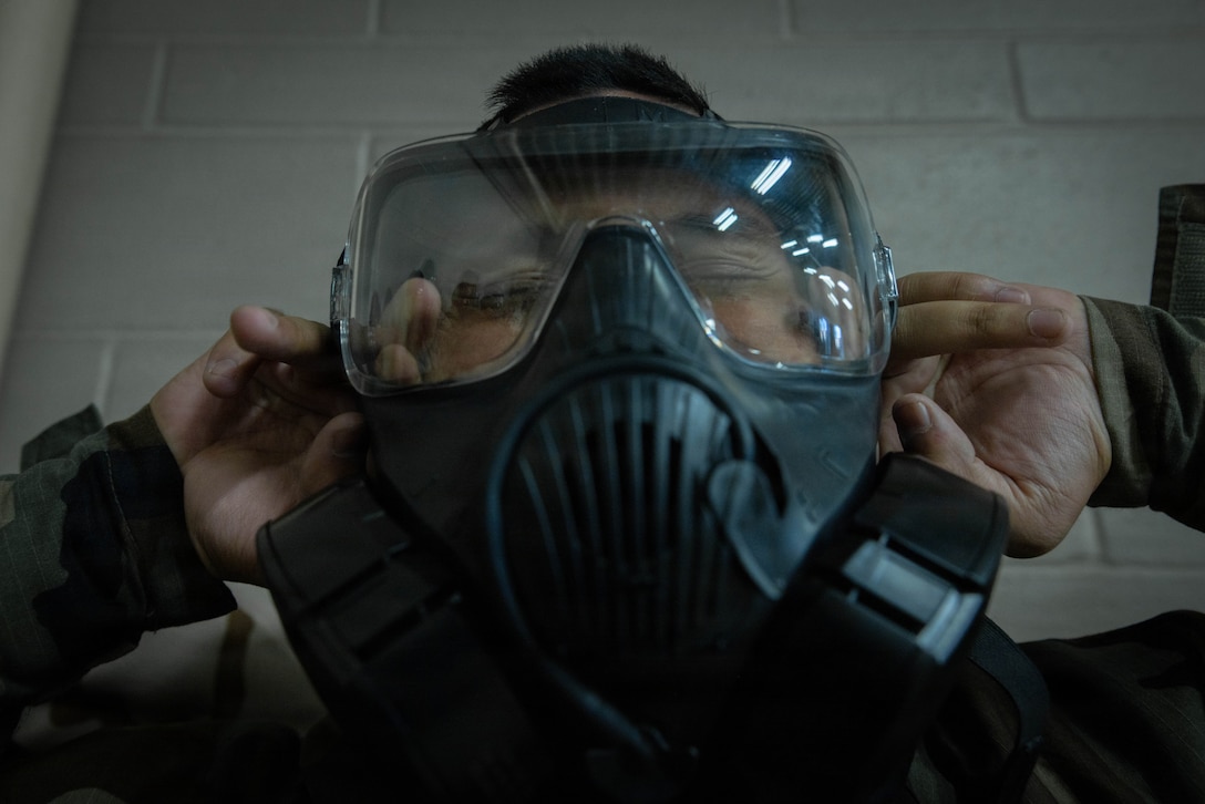 U.S. Marine Corps Lance Cpl. Donald Fraembs, a Chemical, Biological, Radiological and Nuclear Defense Specialist with 4th Medical Battalion, 4th Marine Logistics Group, Marine Forces Reserve, breaks the seal of a gas mask in a gas chamber during a Reserve Mobilization Exercise, East Miramar, California, March 3, 2026. The week-long exercise validates the battalion’s ability to rapidly activate personnel and equipment, ensuring the unit can deliver ready forces in response to a national crisis. (U.S. Marine Corps photo by Lance Cpl. Claire Cheney)