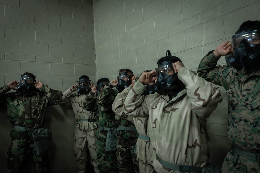 U.S. Marines and Sailors with 4th Medical Battalion, 4th Marine Logistics Group, Marine Forces Reserve, break the seal of a gas mask during a Reserve Mobilization Exercise, East Miramar, California, March 3, 2026. The week-long exercise validates the battalion’s ability to rapidly activate personnel and equipment, ensuring the unit can deliver ready forces in response to a national crisis. (U.S. Marine Corps photo by Lance Cpl. Claire Cheney)