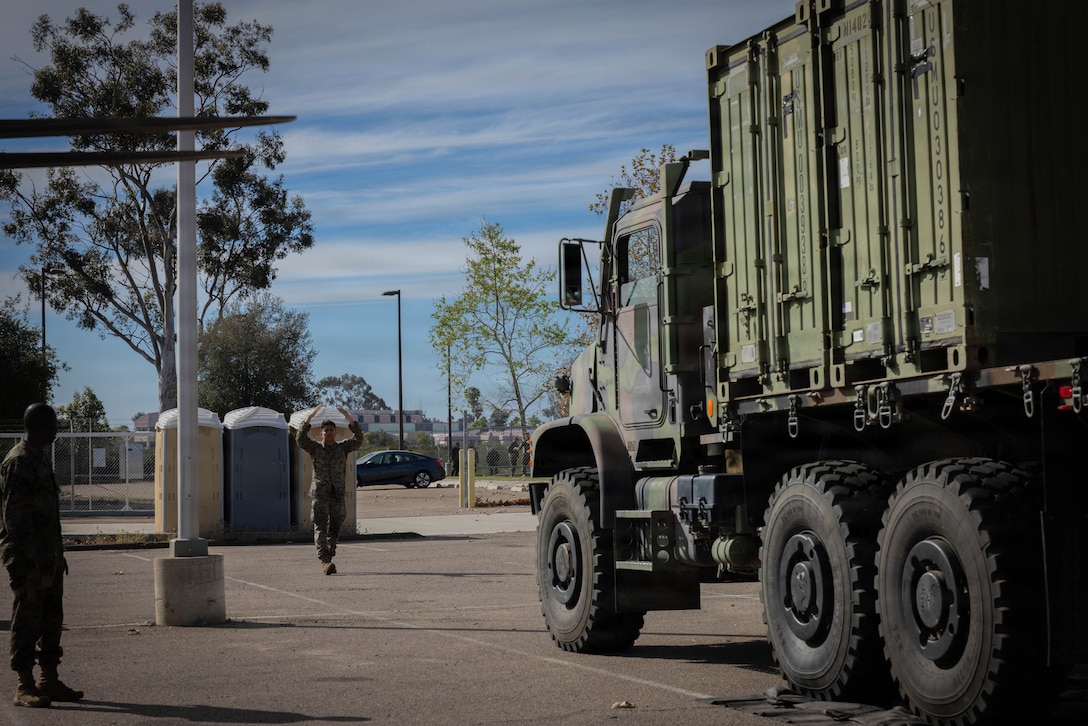 U.S. Marines with 4th Medical Battalion, 4th Marine Logistics Group, Marine Forces Reserve, guide a Medium Tactical Vehicle Replacement during a Reserve Mobilization Exercise, San Diego, California, March 3, 2026. The week-long exercise validates the battalion’s ability to rapidly activate personnel and equipment, ensuring the unit can deliver ready forces in response to a national crisis. (U.S. Marine Corps photo by Lance Cpl. Claire Cheney)