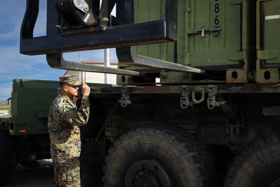 U.S. Marine Corps Lance Cpl. Tristen Porter, a motor vehicle operator with 4th Medical Battalion, 4th Marine Logistics Group, Marine Forces Reserve, guides a forklift when loading a Medium Tactical Vehicle Replacement during a Reserve Mobilization Exercise, San Diego, California, March 3, 2026. The week-long exercise validates the battalion’s ability to rapidly activate personnel and equipment, ensuring the unit can deliver ready forces in response to a national crisis. (U.S. Marine Corps photo by Lance Cpl. Claire Cheney)