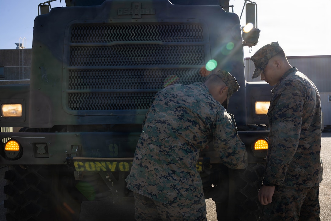 U.S. Marines with 4th Medical Battalion, 4th Marine Logistics Group, Marine Forces Reserve, attach a sign onto a Medium Tactical Vehicle Replacement during a Reserve Mobilization Exercise, San Diego, California, March 3, 2026. The week-long exercise validates the battalion’s ability to rapidly activate personnel and equipment, ensuring the unit can deliver ready forces in response to a national crisis. (U.S. Marine Corps photo by Lance Cpl. Claire Cheney)