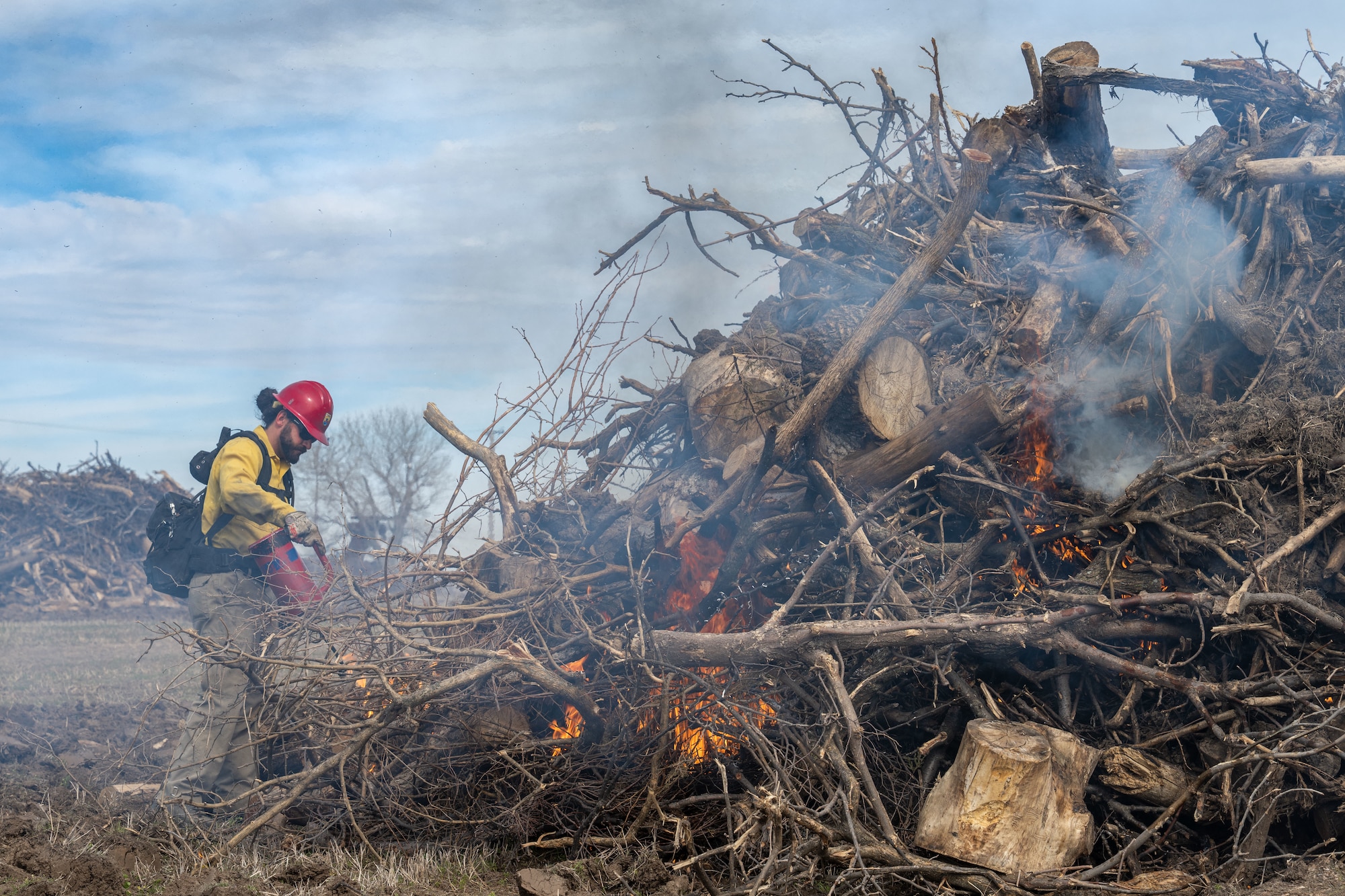 Stephen Slonosky, Bitter Lake Wildlife Refuge engine captain, conducts a controlled burn at McConnell Air Force Base, Kansas, March 18, 2026. Controlled burns are performed to reduce wildfire risk and maintain the base’s ecosystem. (U.S. Air Force photo by Senior Airman Paula Arce)