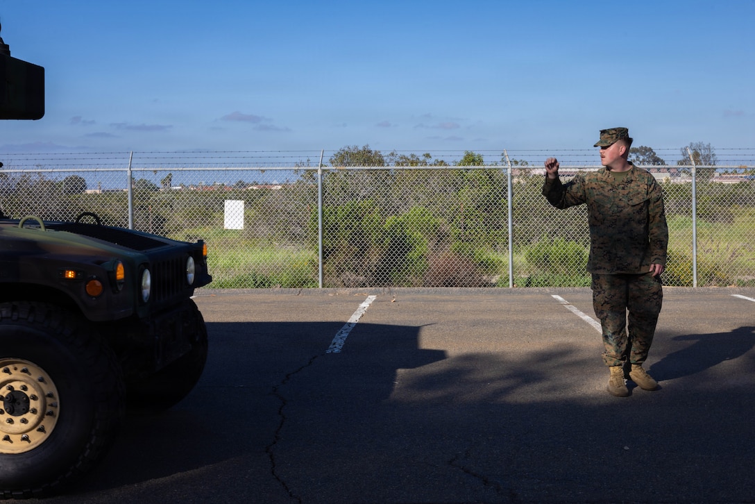 U.S. Marine Corps Pfc. Timothy Burruel, a motor vehicle operator with 4th Medical Battalion, 4th Marine Logistics Group, Marine Forces Reserve, signals a vehicle to halt during a Reserve Mobilization Exercise, San Diego, California, March 3, 2026. The week-long exercise validates the battalion’s ability to rapidly activate personnel and equipment, ensuring the unit can deliver ready forces in response to a national crisis. (U.S. Marine Corps photo by Lance Cpl. Claire Cheney)