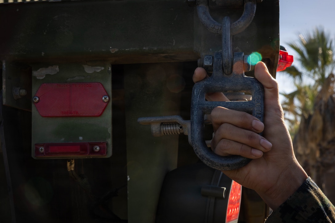 A U.S. Marine with 4th Medical Battalion, 4th Marine Logistics Group, Marine Forces Reserve, holds onto a Medium Tactical Vehicle Replacement during a Reserve Mobilization Exercise, San Diego, California, March 3, 2026. The week-long exercise validates the battalion’s ability to rapidly activate personnel and equipment, ensuring the unit can deliver ready forces in response to a national crisis. (U.S. Marine Corps photo by Lance Cpl. Claire Cheney)
