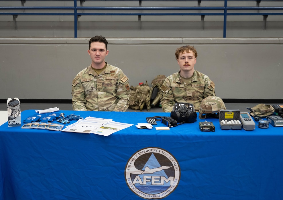 U.S. Air Force Airman 1st Class Corin Armentrout, left, and Senior Airman Jordin Costa, right, 97th Civil Engineer Squadron, emergency management journeymen, pose for a picture at Altus High School, Altus, Oklahoma, March 11, 2026. Armentrout and Costa spoke with local high school students about how emergency management is vital to the Air Force mission. (U.S. Air Force photo by Airman 1st Class Emma Wright)