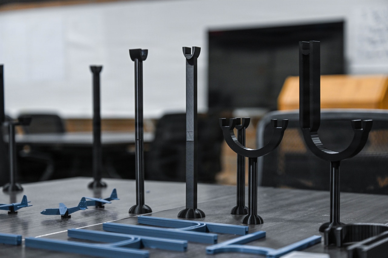 Several tools and 3D printed models are displayed on a table.