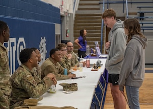 Altus High School students engage in conversation with U.S. Air Force Airmen during a career fair at Altus High School, Altus, Oklahoma, March 11, 2026. Airmen were able to get to know students and share positive experiences about being in the U.S. Air Force. (U.S. Air Force photo by Airman 1st Class Emma Wright)