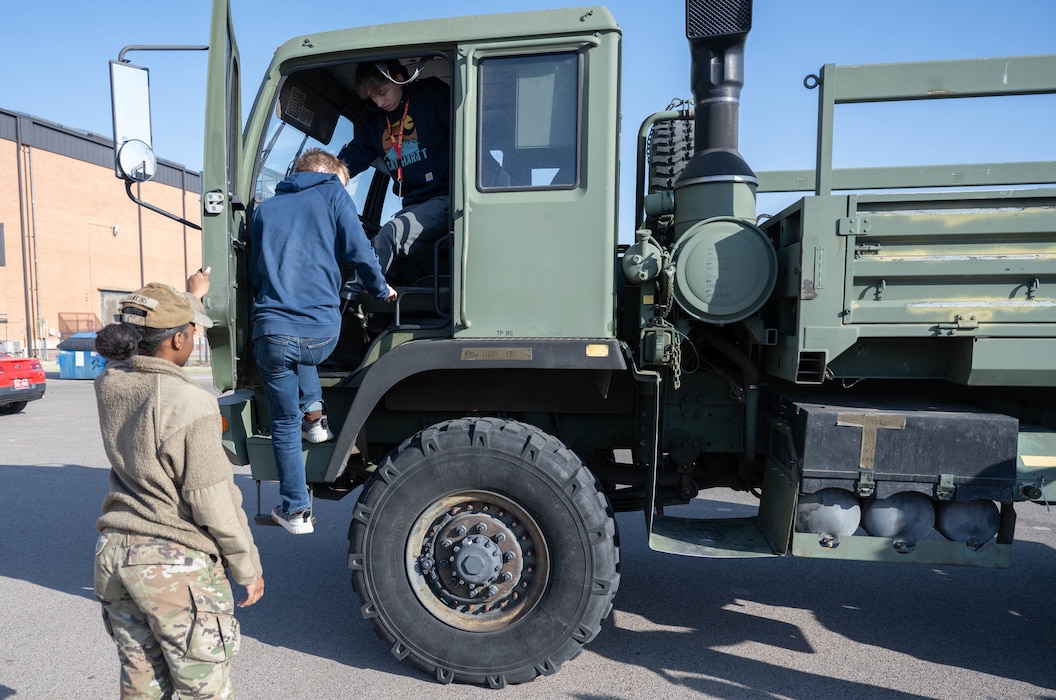 Altus High School students climb off a Family of Medium Tactical Vehicle (FMTV) truck during a career fair at Altus High School, Altus, Oklahoma, March 11, 2026. Local students had the opportunity to sit in the FMTV and learn about how to operate the vehicle. (U.S. Air Force photo by Airman 1st Class Emma Wright)
