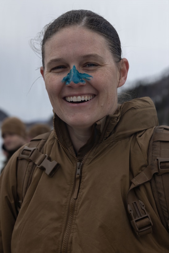 U.S. Marine Corps Capt. Nicole Levermann, a company commander with 4th Law Enforcement Battalion, Force Headquarters Group, has her nose painted blue to symbolize participation in a polar plunge in Elvegardsmoen, Norway, March 10, 2026. The cold plunge is a part of the cold-weather training conducted by NATO partners and allies in preparation for exercise Cold Response 26. A key component of NATO's enhanced vigilance activity Arctic Sentry, exercise Cold Response 26 is a Norwegian-led winter military exercise designed to enhance collective defense capabilities and ensure U.S. readiness to rapidly deploy and seamlessly operate alongside NATO Allies in challenging arctic conditions. Levermann is a native of Massachusetts. (U.S. Marine Corps photo by Sgt. Emily De La Torre)