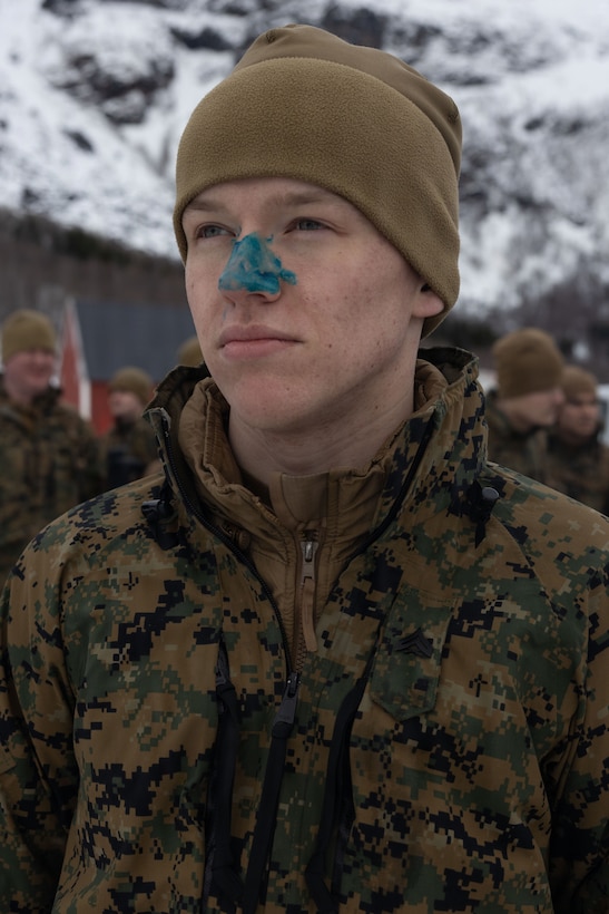 U.S. Marine Corps Cpl. Trevor Boesel, a military police officer with 4th Law Enforcement Battalion, Force Headquarters Group, has his nose painted blue to symbolize participation in a polar plunge in Elvegardsmoen, Norway, March 10, 2026. The cold plunge is a part of the cold-weather training conducted by NATO partners and allies in preparation for exercise Cold Response 26. A key component of NATO's enhanced vigilance activity Arctic Sentry, exercise Cold Response 26 is a Norwegian-led winter military exercise designed to enhance collective defense capabilities and ensure U.S. readiness to rapidly deploy and seamlessly operate alongside NATO Allies in challenging arctic conditions. Boesel is a native of South Dakota. (U.S. Marine Corps photo by Sgt. Emily De La Torre)
