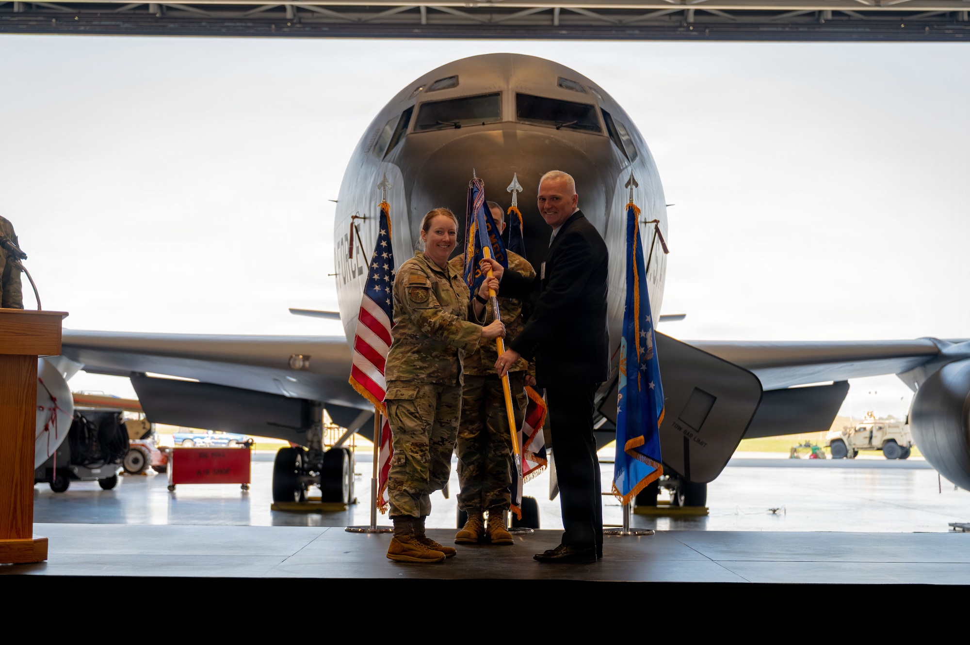 Mr. Brain Keane receives a guidon from U.S. Air Force Lt. Col. Sarah Gilesby, 100th Force Support Squadron commander, as he is appointed Honorary Commander of the 100th FSS at RAF Mildenhall, England, March 19, 2026.
