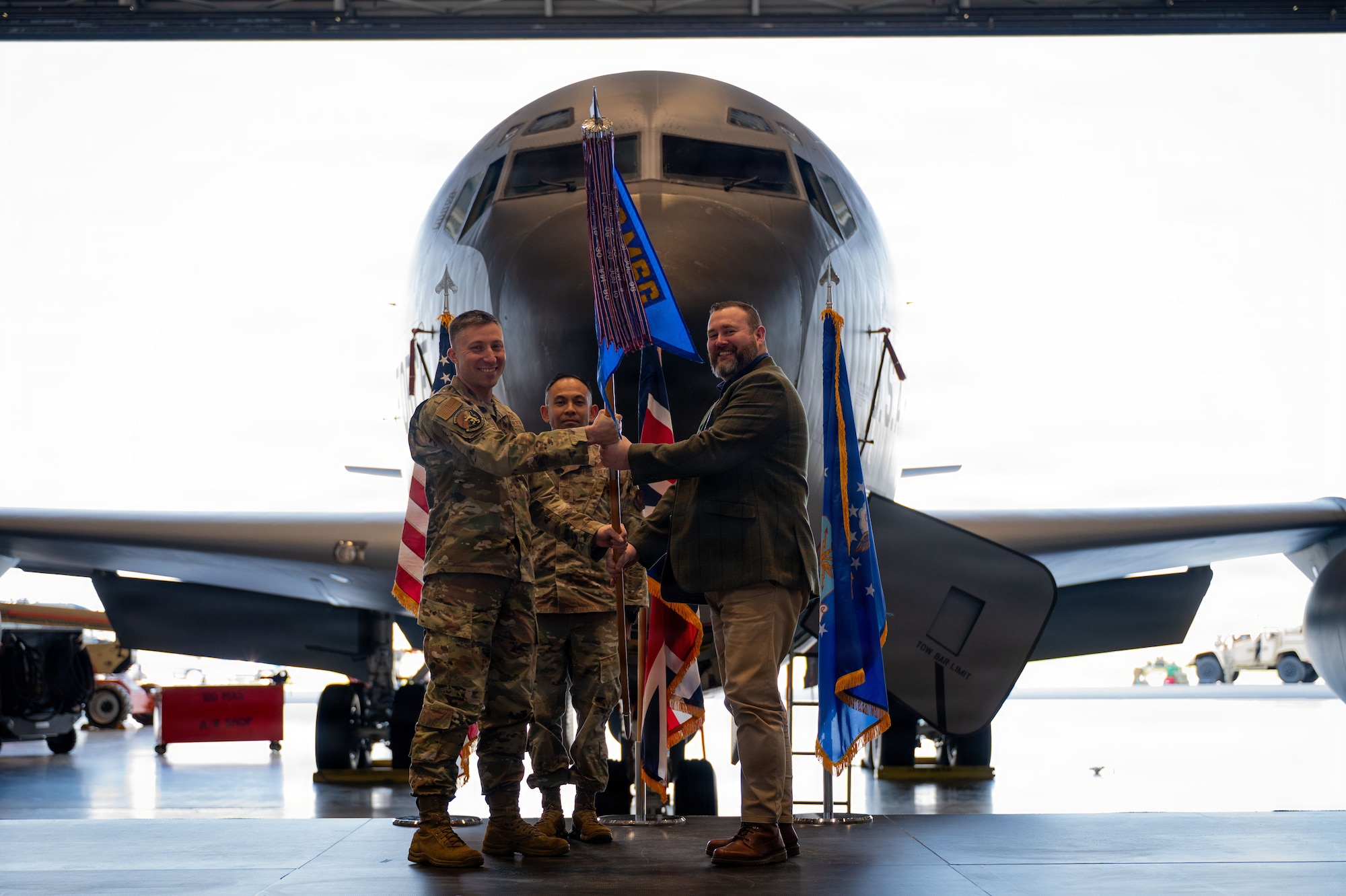 Mr. Dan Whyment receives a guidon from U.S. Air Force Lt. Col. Josh Hager, 100th Civil Engineer Squadron commander, as he is appointed Honorary Commander of the 100th CES at RAF Mildenhall, England, March 19, 2026.
