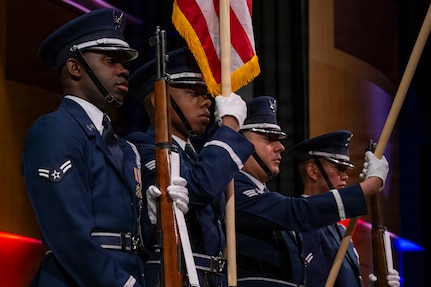 Members of the U.S. Air Force Honor Guard present the colors during a Jazz Heritage Series concert in Alexandria, Va., March 12, 2026. The Honor Guard performed ceremonial honors as part of the long-standing tradition of formally paying respect to the country and fostering unity at the start of an event. (U.S. Air Force photo by Hayden Hallman)