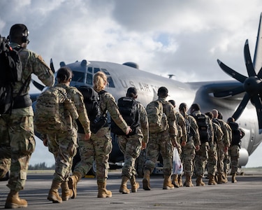 Airmen loading onto C-130