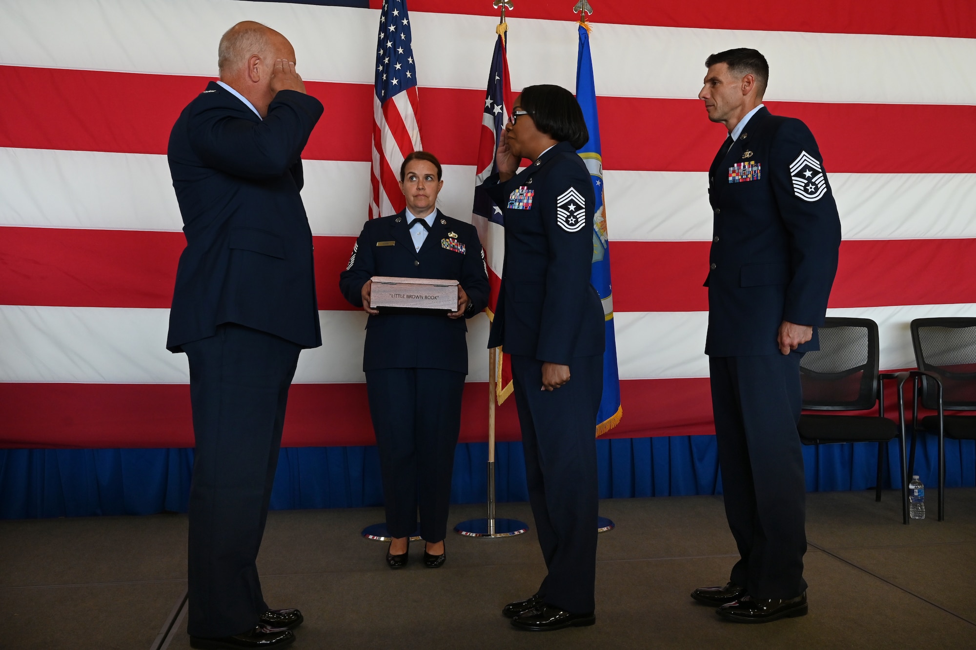 U.S. Air Force Command Chief Master Sgt. Jacquita Melton salutes Col. Donald Braskett, commander of the 178th Wing, during a Change of Authority ceremony Sept. 26, 2025 at the Springfield-Beckley Air National Guard base in Springfield, Ohio. The ceremony signified the transfer of authority and responsibility from one command chief to the next. (U.S. Air National Guard photo by Shane Hughes)