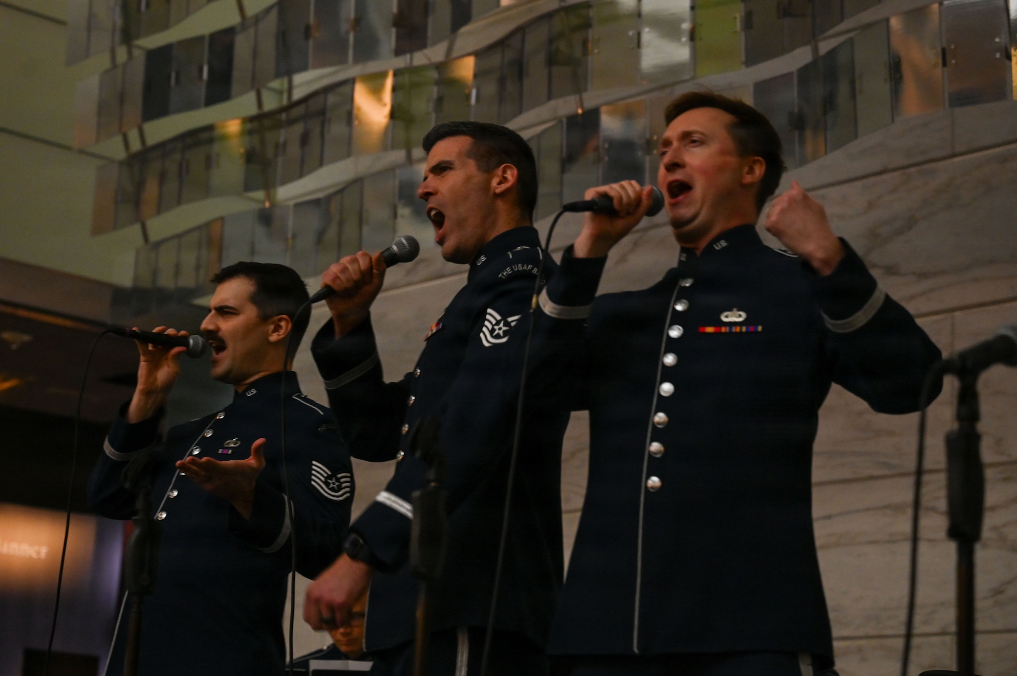 U.S. Air Force Tech. Sgt. Ben Edquist, left, Tech. Sgt. Michael Aiello, center, and Tech. Sgt. Adam von Almen, all vocalists with The U.S. Air Force Band’s Singing Sergeants, sing a selection at the Smithsonian National Museum of American History in Washington, D.C., March 12, 2026. The U.S. Air Force Band vocalists performed while accompanied by a piano, a guitar, and drums. (U.S. Air Force photo by Airman 1st Class Brandon Thomas)