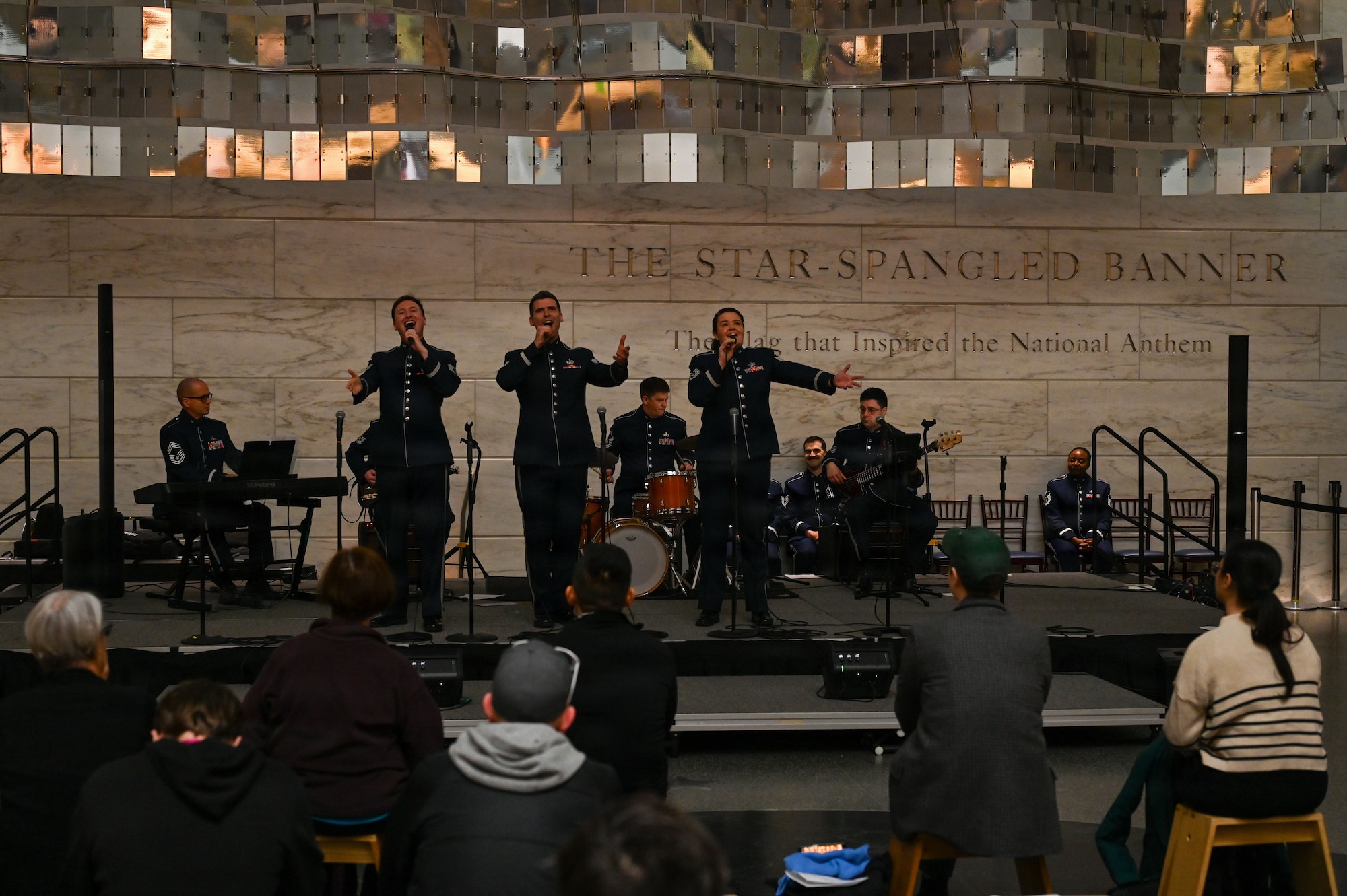 U.S. Air Force Tech. Sgt. Adam von Almen, left, Tech. Sgt. Ben Edquist, center, and Tech. Sgt. Nicole Vander Does, all vocalists with The U.S. Air Force Band’s Singing Sergeants, perform a selection at the Smithsonian National Museum of American History in Washington, D.C., March 12, 2026. The U.S. Air Force Band performed a multitude of songs as a part of a celebration leading up to the 250th birthday celebration of the United States. (U.S. Air Force photo by Airman 1st Class Brandon Thomas)