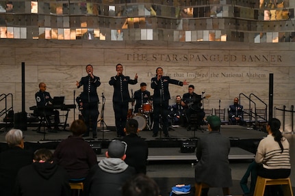 U.S. Air Force Tech. Sgt. Adam von Almen, left, Tech. Sgt. Ben Edquist, center, and Tech. Sgt. Nicole Vander Does, all vocalists with The U.S. Air Force Band’s Singing Sergeants, perform a selection at the Smithsonian National Museum of American History in Washington, D.C., March 12, 2026. The U.S. Air Force Band performed a multitude of songs as a part of a celebration leading up to the 250th birthday celebration of the United States. (U.S. Air Force photo by Airman 1st Class Brandon Thomas)