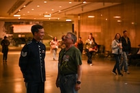 U.S. Air Force Tech. Sgt. Adam von Almen, a vocalist with The U.S. Air Force Band’s Singing Sergeants, talks to a spectator after a show at the Smithsonian National Museum of American History in Washington, D.C., March 12, 2026. The U.S. Air Force Band Singing Sergeants performance was a free non-ticketed event for museum patrons. (U.S. Air Force photo by Airman 1st Class Brandon Thomas)