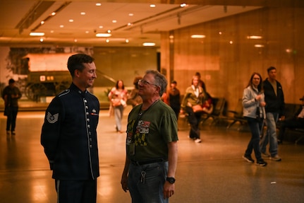 U.S. Air Force Tech. Sgt. Adam von Almen, a vocalist with The U.S. Air Force Band’s Singing Sergeants, talks to a spectator after a show at the Smithsonian National Museum of American History in Washington, D.C., March 12, 2026. The U.S. Air Force Band Singing Sergeants performance was a free non-ticketed event for museum patrons. (U.S. Air Force photo by Airman 1st Class Brandon Thomas)