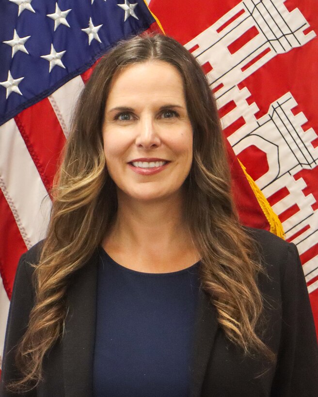 picture of Karyn Adams in front of the American and USACE flags