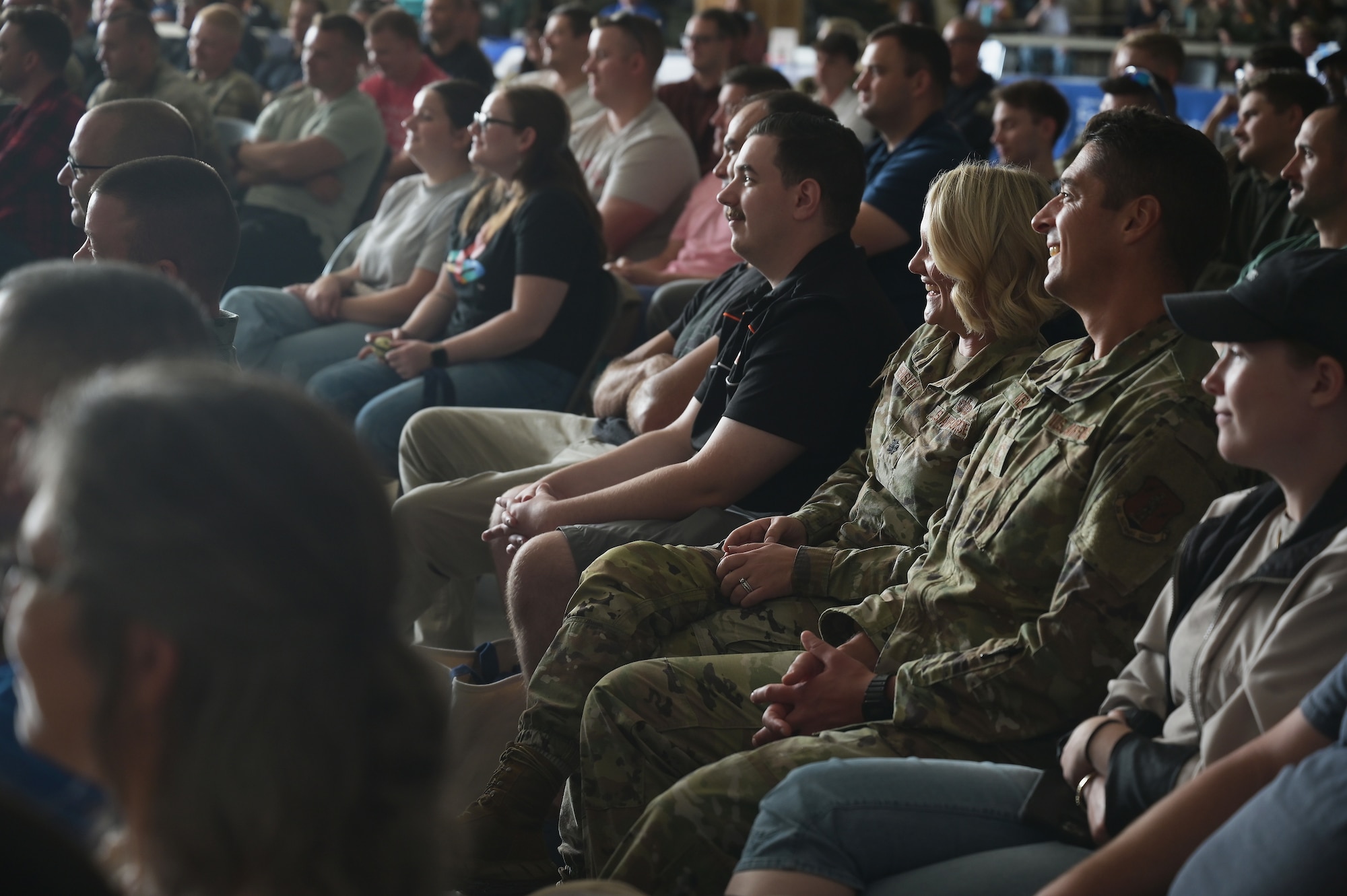 Airmen listen as a comedian delivers jokes Sept. 17, 2025 at the Springfield Air National Guard Base in Springfield, Ohio. Four comedians from One Degree of Separation visited the wing to talk to the airmen about mental health and suicide prevention. (U.S. Air Force photo by Shane Hughes)