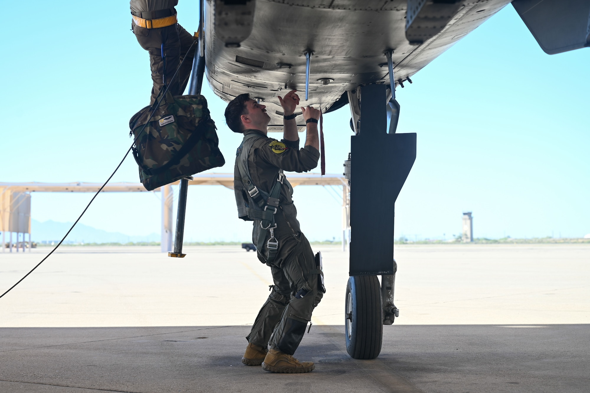 U.S. Air Force 1st Lt. Hunter Mason, a 357th Fighter Squadron A-10C Thunderbolt II pilot, conducts preflight checks before the completion of his mission qualification training at Davis-Monthan Air Force Base, Arizona, March 18, 2026. Mason is part of the final class of A-10 pilots to graduate from the 357th FS. (U.S. Air Force Photo by Airman 1st Class Jaden Kidd)