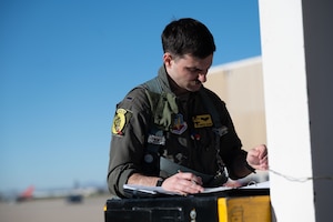 U.S. Air Force 1st Lt. Hunter Mason, a 357th Fighter Squadron A-10C Thunderbolt II pilot, performs preflight checks prior to the final training exercise on Davis-Monthan Air Force Base, Arizona, March 18, 2026. Mason was preparing for the final flight exercise needed to complete his mission qualification training. (U.S. Air Force photo by Airman Najzee Kuzu)