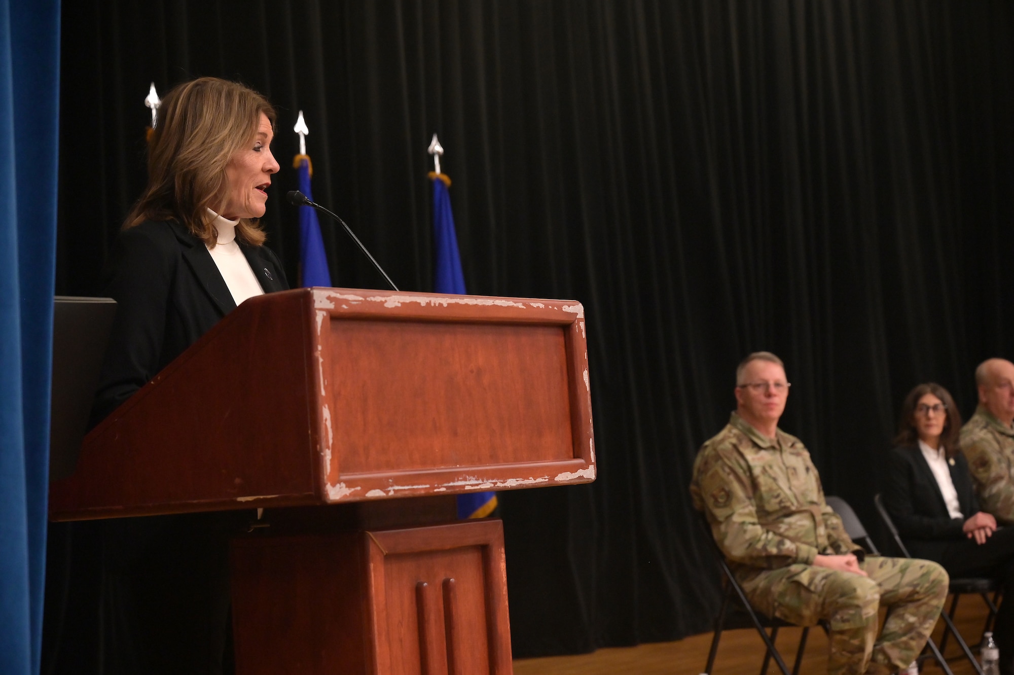 Jill Cole, mayor of Blue Ash, speaks to the airmen of the 123rd Air Control Squadron during a homecoming ceremony Dec. 7, 2025 in the auditorium at Muntz Hall at the University of Cincinnati campus in. Blue Ash, Ohio. Nearly 300 airmen assigned to the 123rd Air Control Squadron returned home from a six-month deployment supporting U.S. Air Forces Central Command. (U.S. Air Force photo by Shane Hughes)