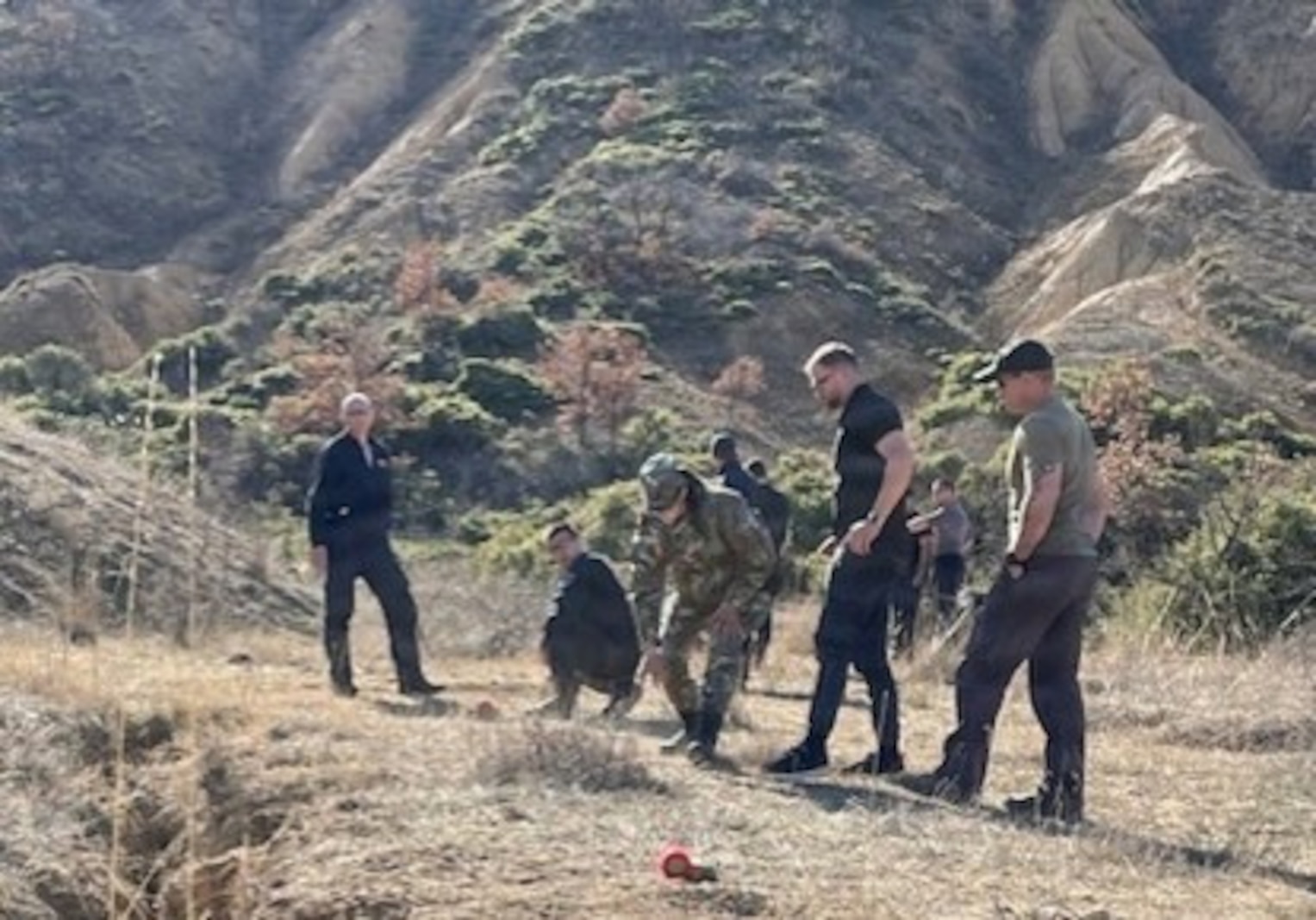 A photo depicting Instructors from the North Macedonia army leading their students in a live "blow-in-place" demolition exercise in North Macedonia. The training scenario involved safely destroying munitions where they were found, a critical skill for EOD technicians.