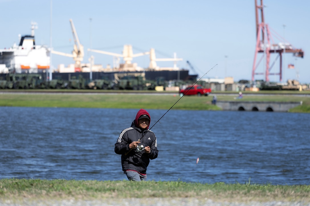 Gordon Ignacio, an information technology specialist at Marine Corps Support Facility Blount Island, participates in a fishing tournament March 18, 2026, in a stormwater pond on the installation in Florida. Hosted by the facility’s environmental team, the event supported required natural resource surveys under the Integrated Natural Resources Management Plan, using the pond to assess habitat conditions and water quality indicators tied to installation resilience. Despite a sharp temperature drop limiting catches, the effort reinforced workforce cohesion and highlighted the role of Marines, civilians, contractors and veterans in sustaining environmental stewardship alongside logistics operations that enable Marine Corps global response. (Official Marine Corps photo by Dustin Senger)
