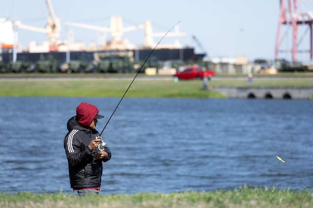 Gordon Ignacio, an information technology specialist at Marine Corps Support Facility Blount Island, participates in a fishing tournament March 18, 2026, in a stormwater pond on the installation in Florida. Hosted by the facility’s environmental team, the event supported required natural resource surveys under the Integrated Natural Resources Management Plan, using the pond to assess habitat conditions and water quality indicators tied to installation resilience. Despite a sharp temperature drop limiting catches, the effort reinforced workforce cohesion and highlighted the role of Marines, civilians, contractors and veterans in sustaining environmental stewardship alongside logistics operations that enable Marine Corps global response. (Official Marine Corps photo by Dustin Senger)