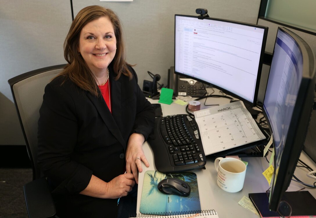 Picture of a woman sitting at a computer.