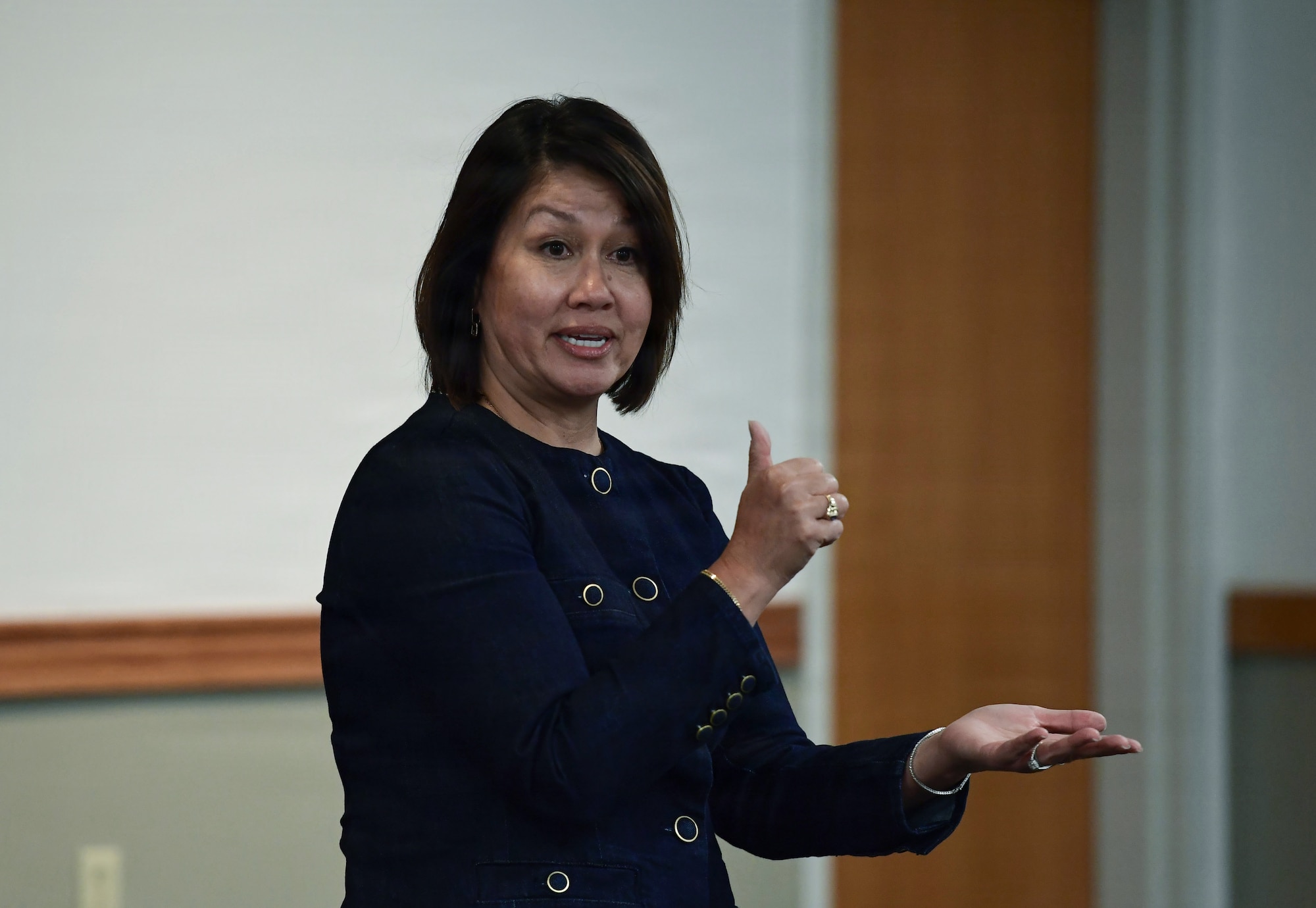A woman speaks with hand gestures.